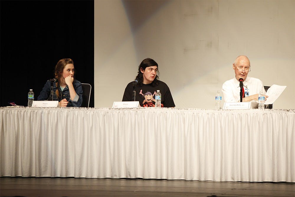 From left, Kayla and Blaze listen as Dr. Joel Griffith speaks during the second session of the "Sex, Drugs, and Suicide" panel at Bloomington High School North on Sunday.  The two teenagers talked about their personal experience on the subject, and later answered questions from the audience.