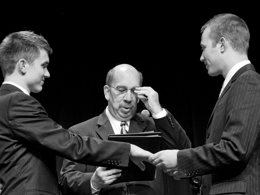 Then-juniors Matthew Sullivan and Nick Ready say their vows as Doug Bauder, director of the LGBTQ+ Culture Center,officiates on Nov. 5, 2009, in the Whittenberger Auditorium during a demonstration wedding.