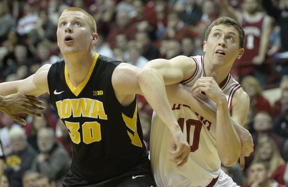 Junior forward Ryan Burton attempts to box out an Iowa defender.
