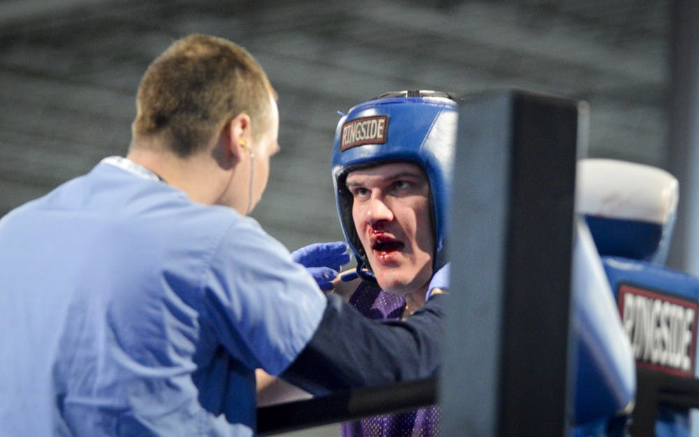 The fight between Fiji’s Ben Powell and Delta Chi’s Andrew Rusk comes to an end as Powell suffers a bloody nose during the Last Man Standing event Friday evening in The Warehouse.