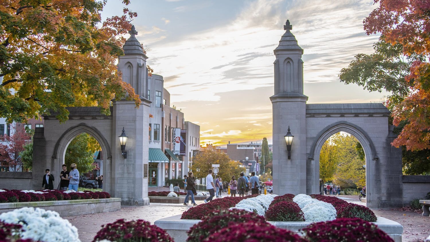 The sun sets Oct. 10 behind the Sample Gates.