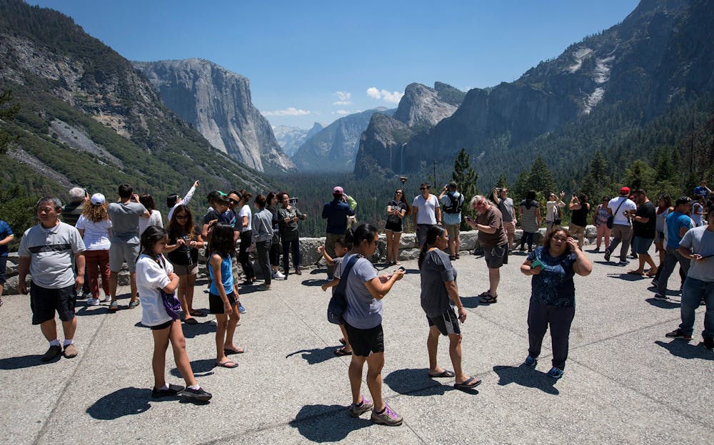 <p>Visitors crowd Tunnel View overlooking Yosemite Valley in Yosemite National Park. The Trump administration is mulling proposals to privatize national park campgrounds and further commercialize the parks with expanded Wi-Fi service, food trucks and even Amazon deliveries at tourist camp sites. </p>