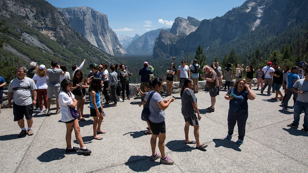 Visitors crowd Tunnel View overlooking Yosemite Valley in Yosemite National Park. The Trump administration is mulling proposals to privatize national park campgrounds and further commercialize the parks with expanded Wi-Fi service, food trucks and even Amazon deliveries at tourist camp sites. 