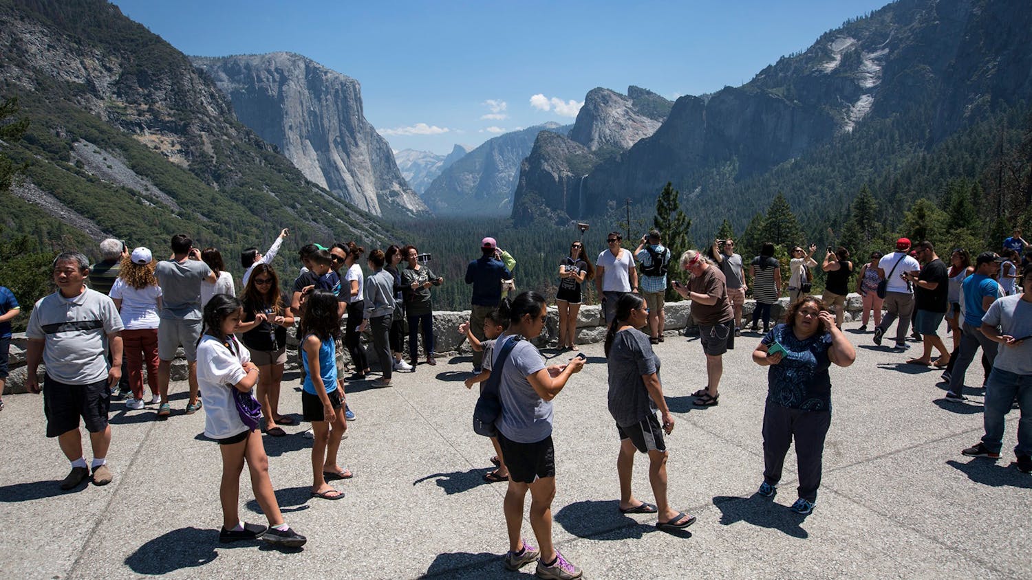 Visitors crowd Tunnel View overlooking Yosemite Valley in Yosemite National Park. The Trump administration is mulling proposals to privatize national park campgrounds and further commercialize the parks with expanded Wi-Fi service, food trucks and even Amazon deliveries at tourist camp sites. 
