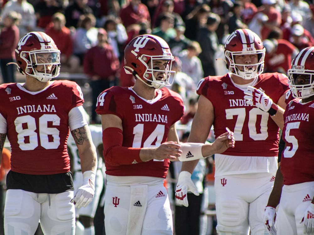 Junior quarterback Jack Tuttle gathers the offense against Michigan State on Oct. 16, 2021, at Memorial Stadium. Indiana announced Chad Wilt as the team&#x27;s new defensive coordinator Friday.