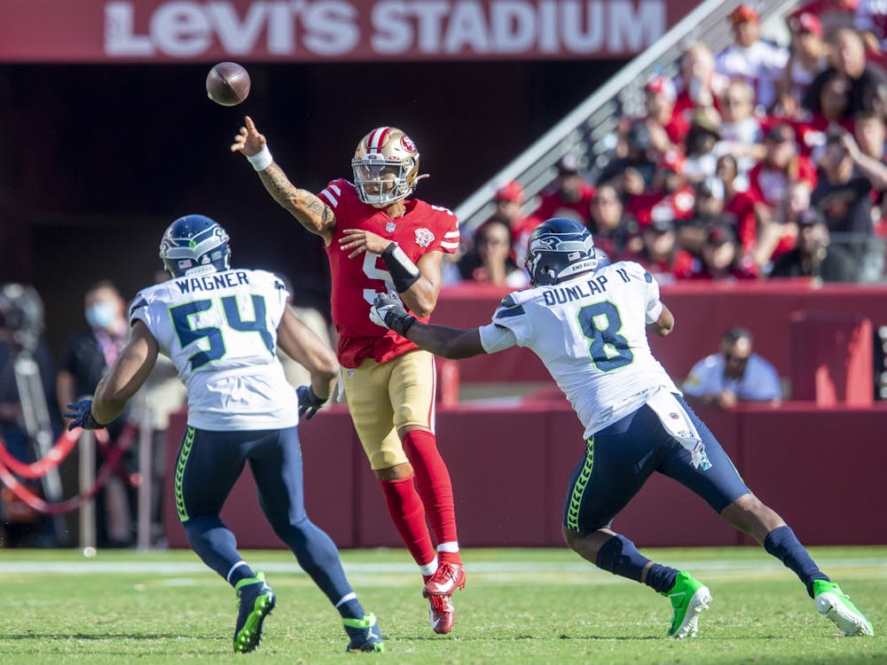 San Francisco 49ers quarterback Trey Lance passes over the rush of Seattle Seahawks&#x27; Bobby Wagner and Carlos Dunlap II﻿ Oct. 3, 2021, at Levi&#x27;s Stadium in Santa Clara, California.