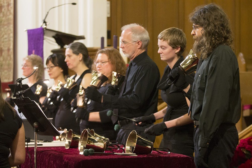 Ringers play during the Symphonic Bells of Bloomington Winter Concert on Tuesday at the First United Methodist Church. Ringers played renditions of multiple songs, from "Stairway to Heaven" to "We Three Kings."