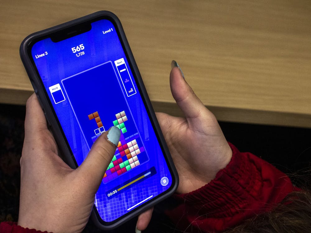 Junior Abby Carmichael plays Tetris on a phone Dec. 7, 2021.