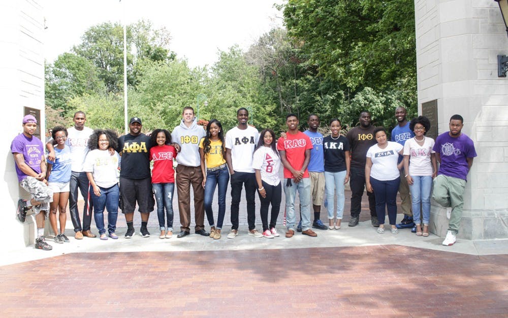 <p>Representatives from the nine historically black fraternities and sororities at IU pose for a photo by Sample Gates. A permanent row of limestone markers will have the names of the United States'&nbsp;nine original black greek chapters &mdash; known as the "Divine Nine" &mdash;&nbsp;arranged in an arc along the sidewalk that leads to the entrance of the Neal-Marshall Black Culture Center building.</p>