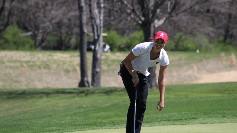 Freshman Emma Fisher picks her ball out of the hole after sinking a putt Saturday, April 8, 2017, during the IU Invitational at the IU Golf Course. The IU women's golf team will take part in the Alexa Stirling Women's Intercollegiate this weekend.