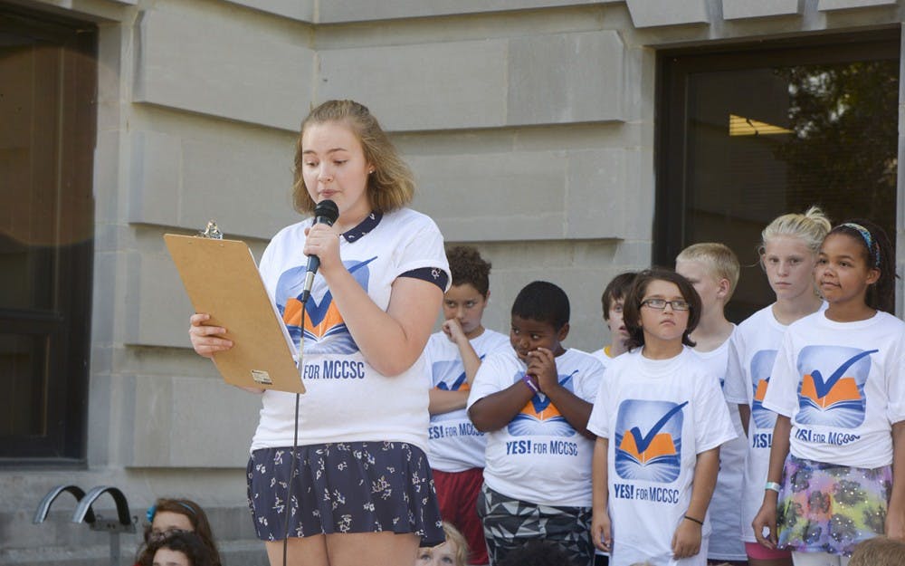 Zoe Berenstein, junior from the Bloomington South High School, speaks in a Rally, “Yes For MCCSC needs YOU” on Tuesday evening at the Monroe County Courthouse. Berenstein shared how public education helped her improve language. 