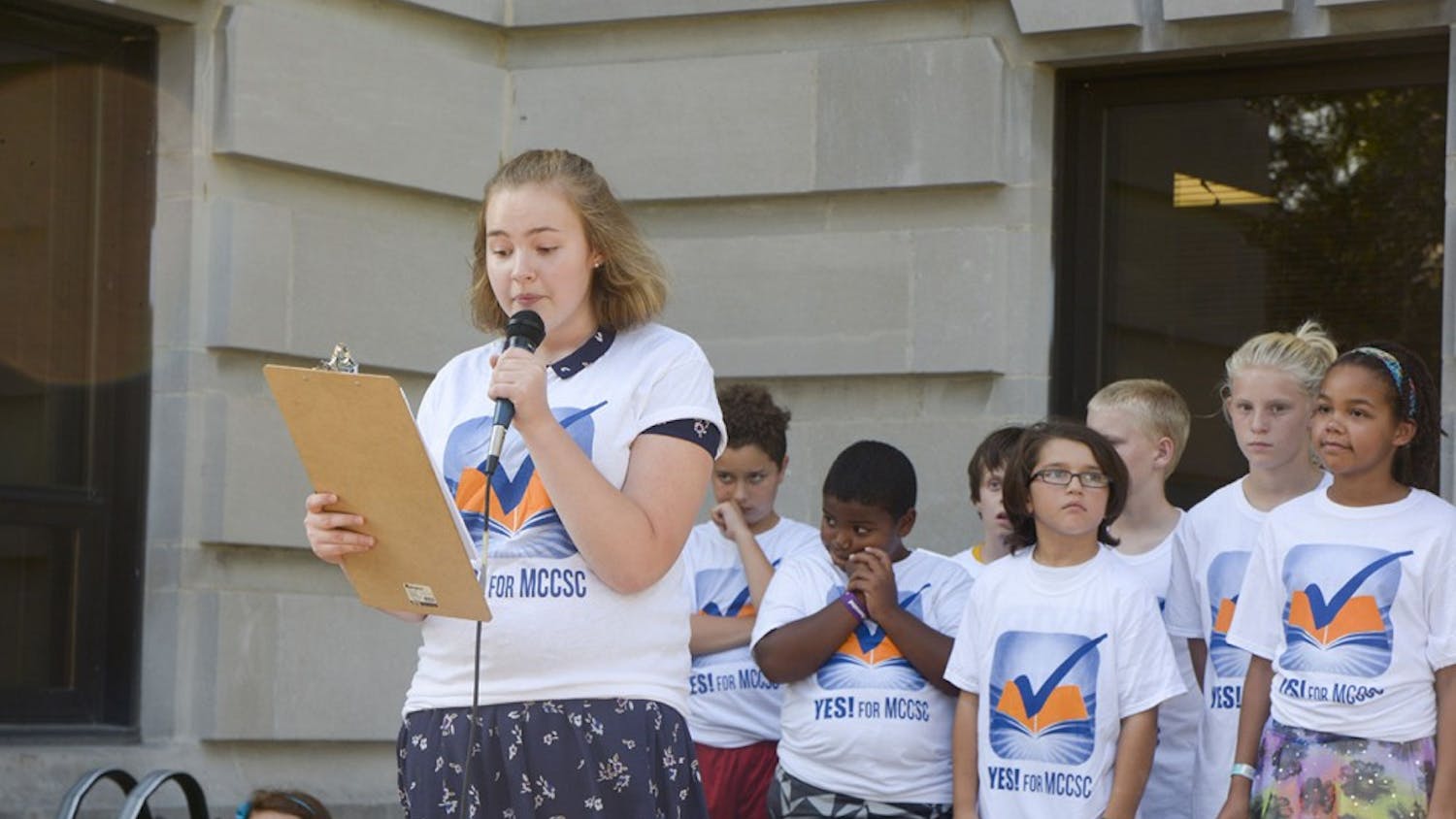 Zoe Berenstein, junior from the Bloomington South High School, speaks in a Rally, “Yes For MCCSC needs YOU” on Tuesday evening at the Monroe County Courthouse. Berenstein shared how public education helped her improve language. 