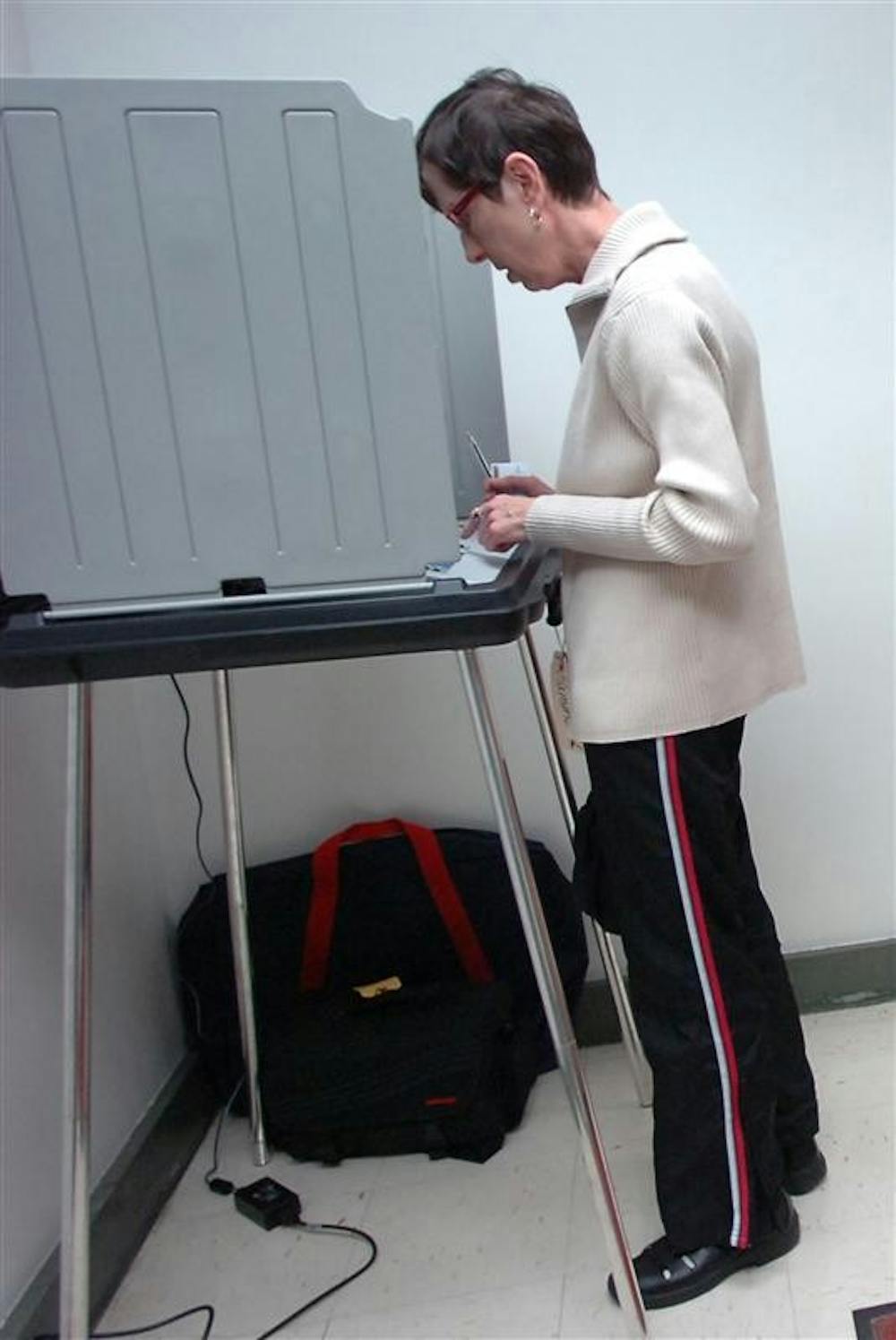 Joan Austgen of Highland, Ind. is the second person to vote on Tuesday at the Lake County Courthouse in Hammond, Ind.  Computer glitches delayed the early voting Tuesday leading to some people waiting for hours, before some of them gave up for the day.