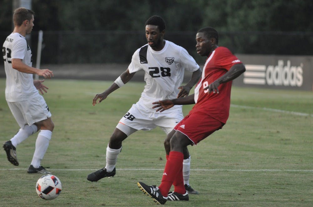 Junior forward Rashad Hyacenth keeps the ball away from a pair of Oakland players during the Hoosier's exhibition game on Thursday. IU won 4-0.