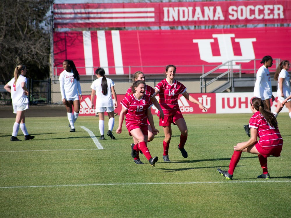 Players on the IU women&#x27;s soccer team celebrate Feb. 25 during the game against Rutgers. The No. 24 Hoosiers won against the Maryland Terrapins 3-2 Sunday.  