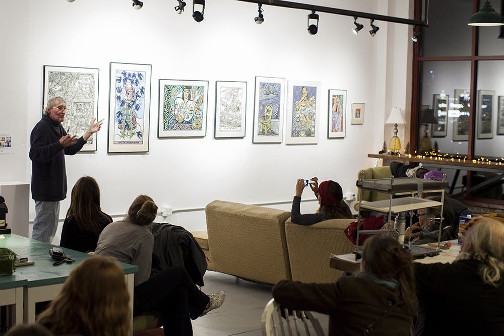 Printmaker Jim Simpson talks about his linocut prints at Blueline Media Productions on Thursday.  His work will be on display until Jan. 30th.