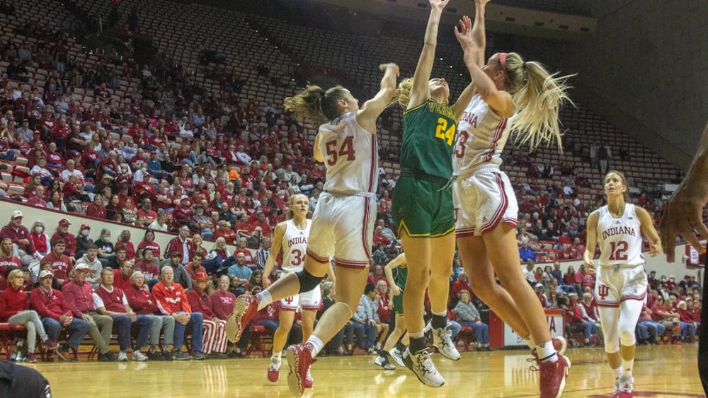 Senior forward Mackenzie Holmes and junior guard Sydney Parrish attempt to block a shot during the game against University of Vermont Nov. 8, 2022, at Simon Skjodt Assembly Hall. Indiana women&#x27;s basketball defeated Northwestern University on Sunday.