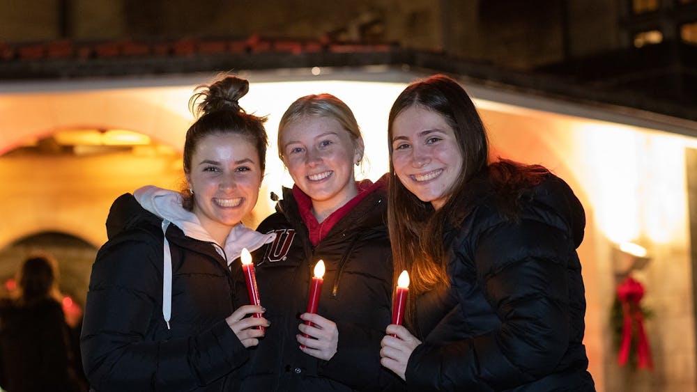 Students pose for a photo during the Indiana Memorial Union&#x27;s annual &quot;Light Up the Night&quot; event Dec. 1, 2021, outside of the IMU. Students and Bloomington residents are invited to visit the fourth annual Light Up the Night holiday celebration event at 7 p.m. Dec. 1 at the IMU Circle Drive and Robel Plaza.