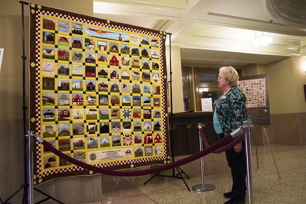 Cheryl Munson, who is involved with the County Council, looks at the Indiana Bicentennial Barn Quilt Monday at the Monroe County Courthouse. The quilt depicts Indiana's 92 counties and will be auctioned off to support barn preservation in 2017.