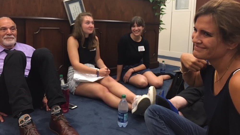 IU sophomore Annie King and graduate student Tracey Hutchings-Goetz sit on the floor of Sen. Joe Donnelly, D-Indiana's office in Washington on Tuesday. The group of Hoosiers were protesting the nomination of Brett Kavanaugh to the Supreme Court.