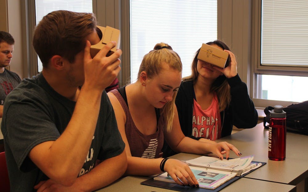 Freshman Kurt Simpson, sophomore Kelsey Harper and freshman Skyler Blanton use the Google Cardboard Viewers to see 360 degree images of Spanish countries. Lecturer Olga Scrivner incorporates virtual reality into her beginning Spanish course.