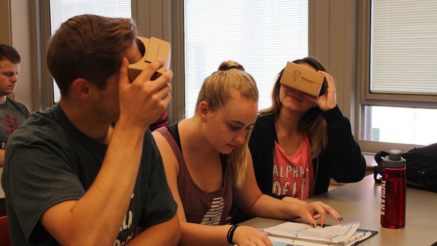 Freshman Kurt Simpson, sophomore Kelsey Harper and freshman Skyler Blanton use the Google Cardboard Viewers to see 360 degree images of Spanish countries. Lecturer Olga Scrivner incorporates virtual reality into her beginning Spanish course.