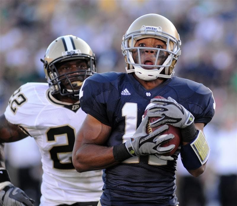 Notre Dame wide receiver David Grimes, front, heads for the end zone with a touchdown as Purdue safety Dwight Mclean gives chase during third-quarter action in an NCAA college football game Saturday, Sept. 27, 2008, in South Bend, Ind.