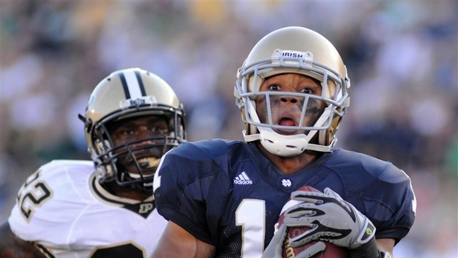 Notre Dame wide receiver David Grimes, front, heads for the end zone with a touchdown as Purdue safety Dwight Mclean gives chase during third-quarter action in an NCAA college football game Saturday, Sept. 27, 2008, in South Bend, Ind.