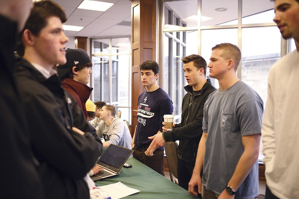 Members of Beta Theta Pi talk to prospective members at the Meet and Greet in the IMU Solarium on Sunday afternoon. 