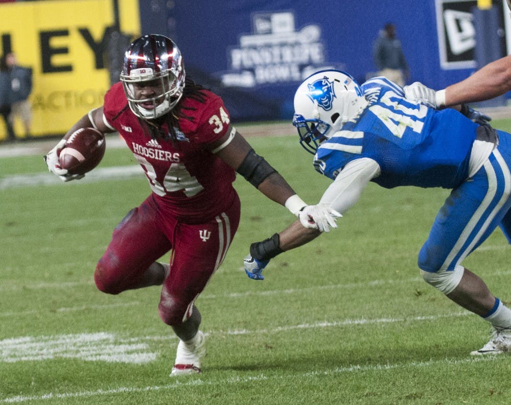 Running back Devine Redding attempts to evade Duke linebacker Dwayne Norman during the Pinstripe Bowl on Dec. 26, 2015 at Yankee Stadium.