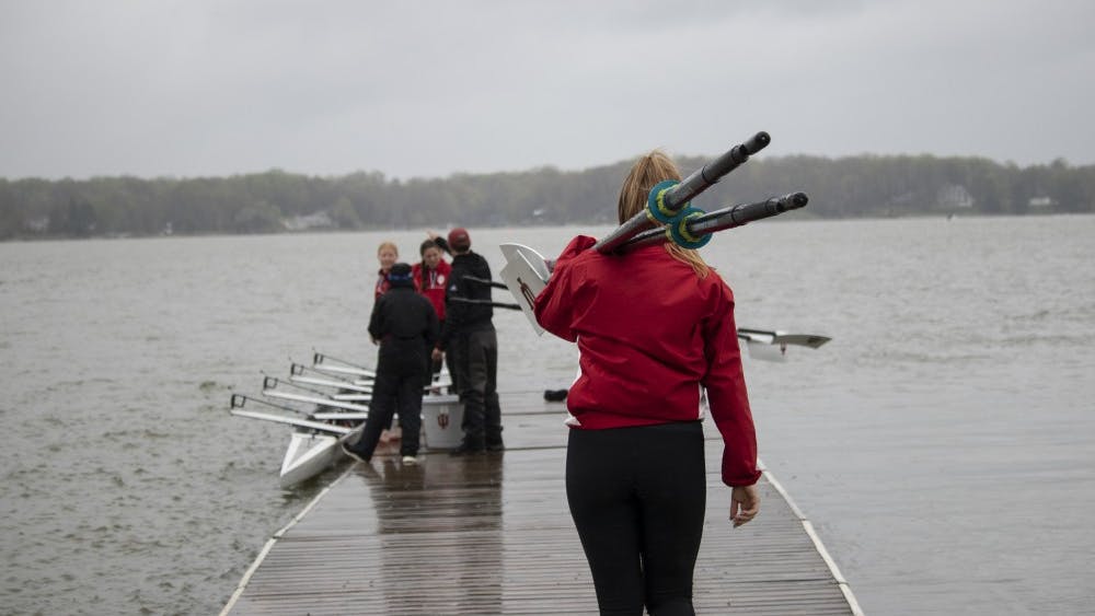 Rowers prepare their boats April 20 at Dale England Rowing Center on Lake Lemon. IU won with 72 points in the 11th annual Dale England Cup against the University of Notre Dame and Michigan State. 