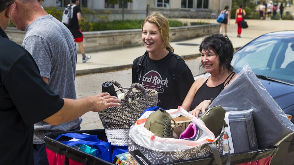 Then-freshman Morgan Sell smiles as her parents help her move into Spruce Hall on Aug. 19, 2019. Both IU and the City of Bloomington sponsor many different kinds of events throughout the year new students are welcome to attend.