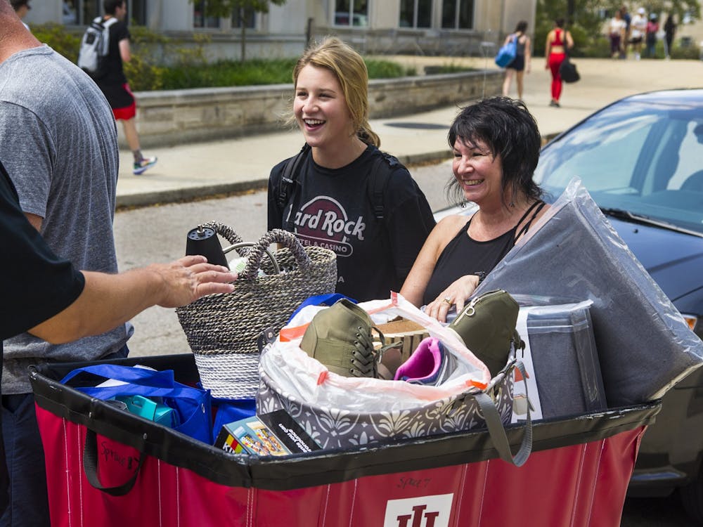 Then-freshman Morgan Sell smiles as her parents help her move into Spruce Hall on Aug. 19, 2019. Both IU and the City of Bloomington sponsor many different kinds of events throughout the year new students are welcome to attend.
