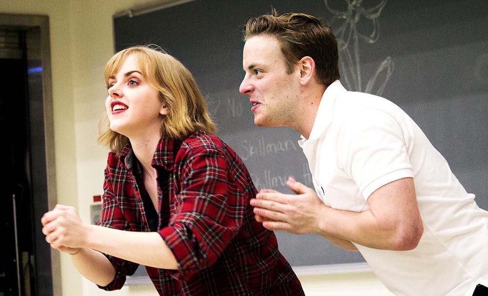 Amy Reader, left, and Jack Hagedorn practice an improvization game during a rehearsal leading up to their show the "Indiana University Campus Comedy Festival" Wednesday at Woodburn Room 100. Reader and Hagedorn played the game called "Three Lines" as the rest of Midnight Snack cast watched and laughed along.