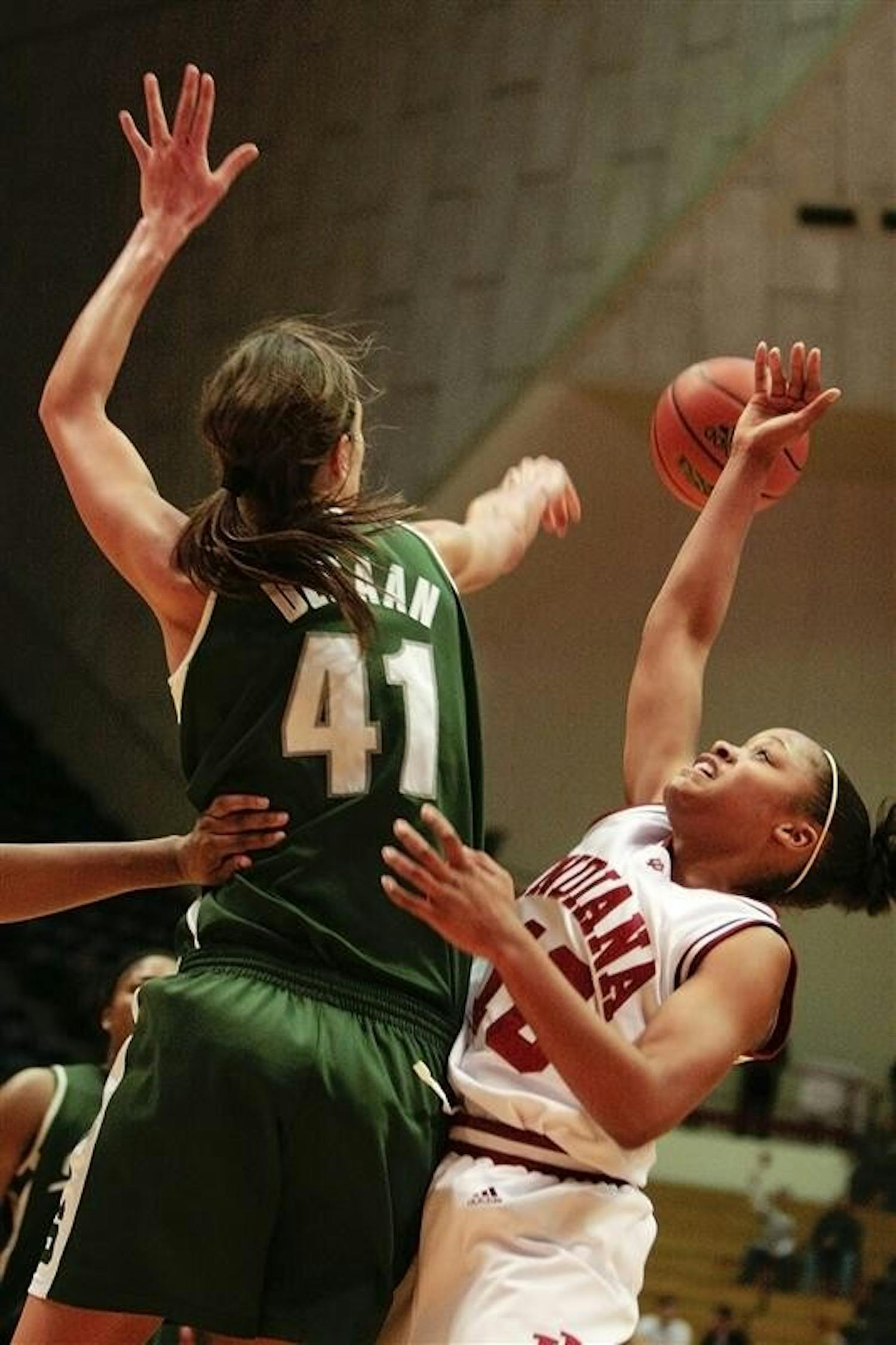 Sophomore guard Andrea McGuirt has her shot rejected by Michigan State's 6-foot-9-inch center Allyssa DeHann during the Hoosiers 71-65 loss to the Spartans February 12 at Assembly Hall.