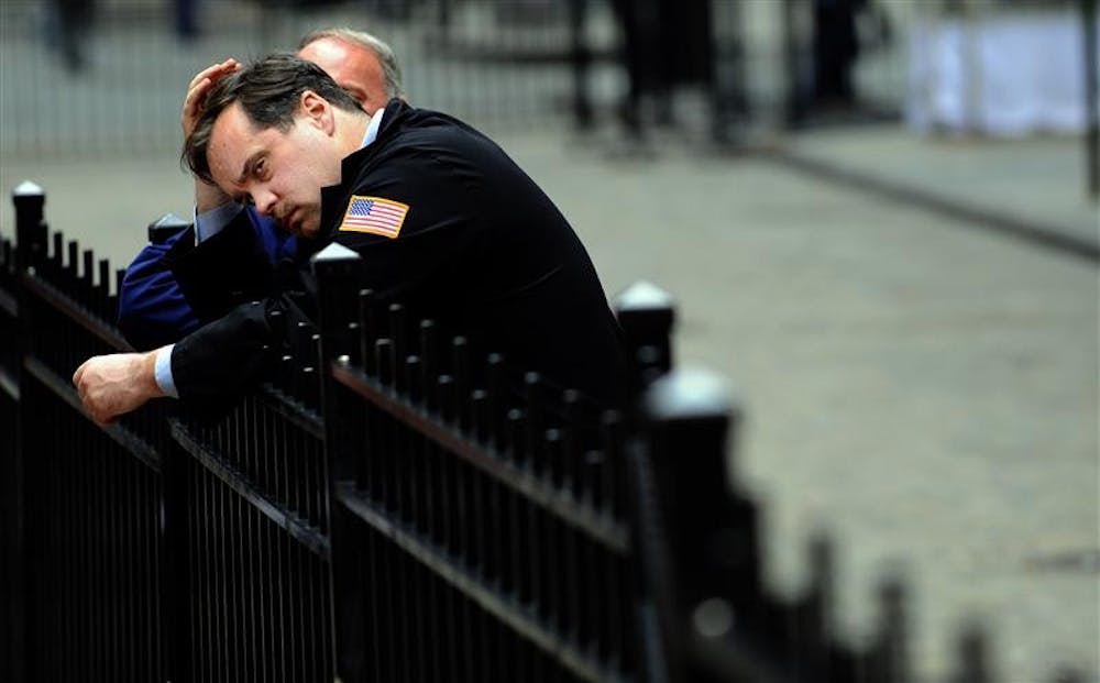 A trader takes a break as the Dow Jones Industrial Average plummets Monday in front of the New York Stock Exchange in New York. Fear swept across the financial markets Monday, sending the Dow Jones industrials down as much as 705 points, after the government's financial bailout package failed to survive a vote in the House.