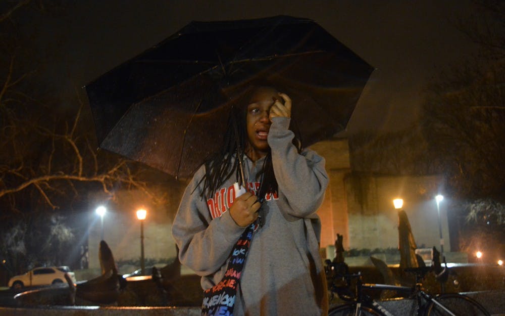 Freshman Alese Allen cries as she recalls fond memories of Djiby. Students gathered at Showalter Fountain to tell others how the c-store worker changed their lives.