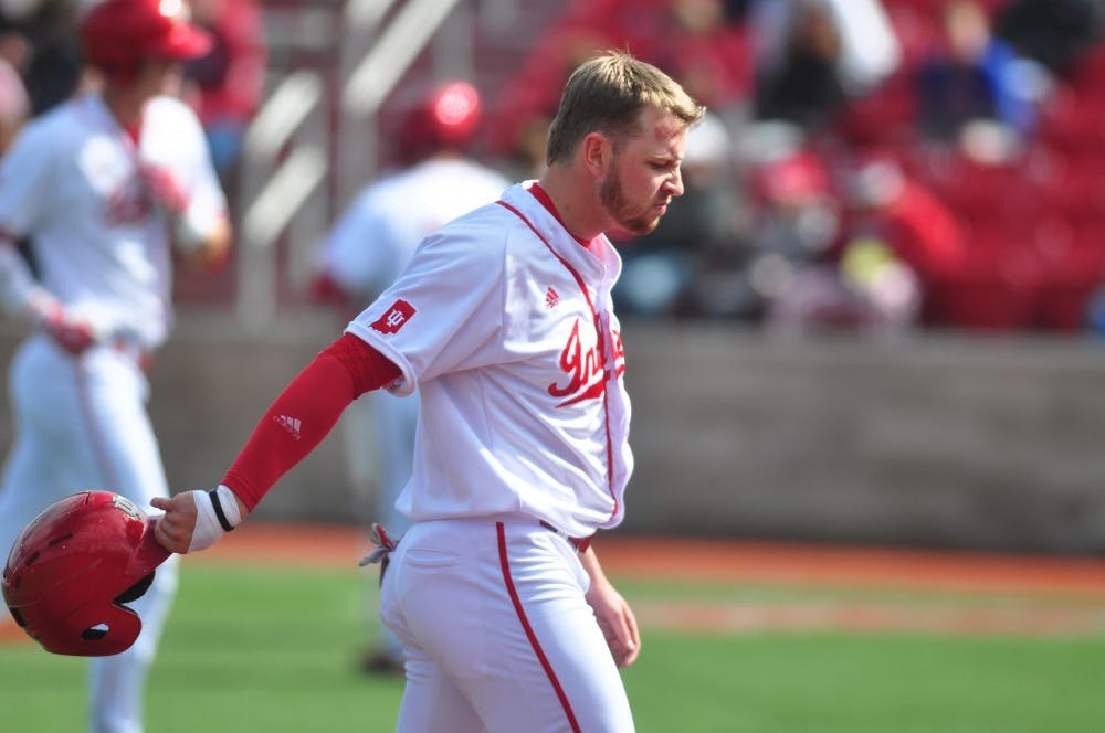 Sophomore Matt LLoyd walks back to the dugout after a double play ends the Hoosiers’ scoring chance in the ninth inning on Saturday. IU lost to Nebraska 3-1.