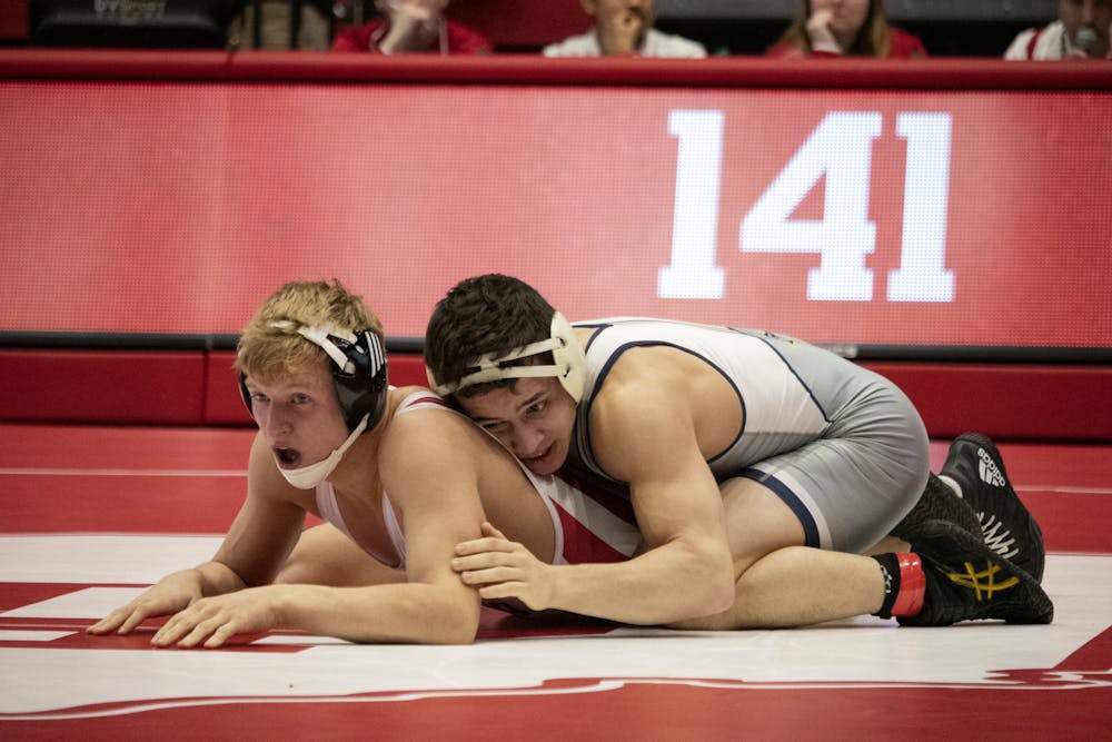 Then-freshman, now sophomore Kyle Luigs wrestles against junior Chris Debien on Feb. 24 in Wilkinson Hall. Luigs was arrested early Tuesday morning in Evansville, Indiana, while celebrating his 21st birthday.