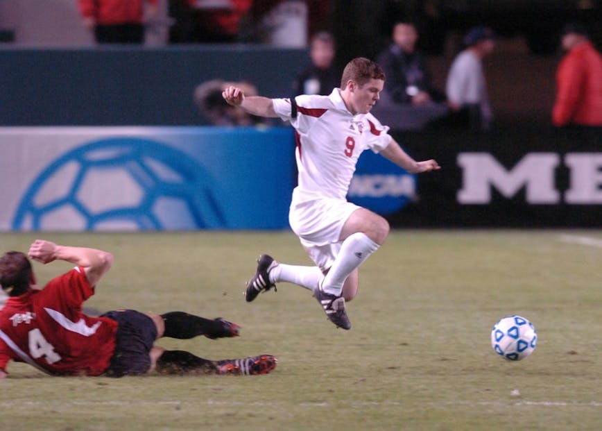 IU junior Michael Ambersley dribbles past a Maryland player during a 2004 NCAA College Cup semifinal match at the StubHub Center, then known as the Home Depot Center, in Carson, California. The Hoosiers defeated Maryland in overtime to advance to the National Championship match against the University of California at Santa Barbara.