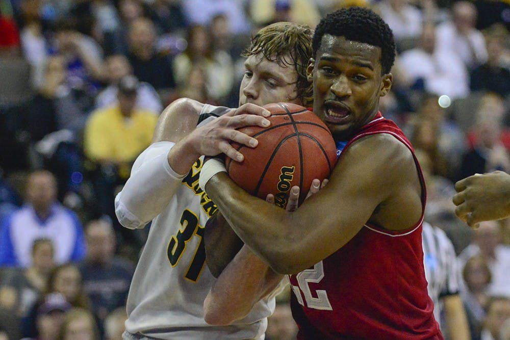 Sophomore guard Stan Robinson fights for the ball against Wichita State on Friday at CenturyLink Center in Omaha, Neb.