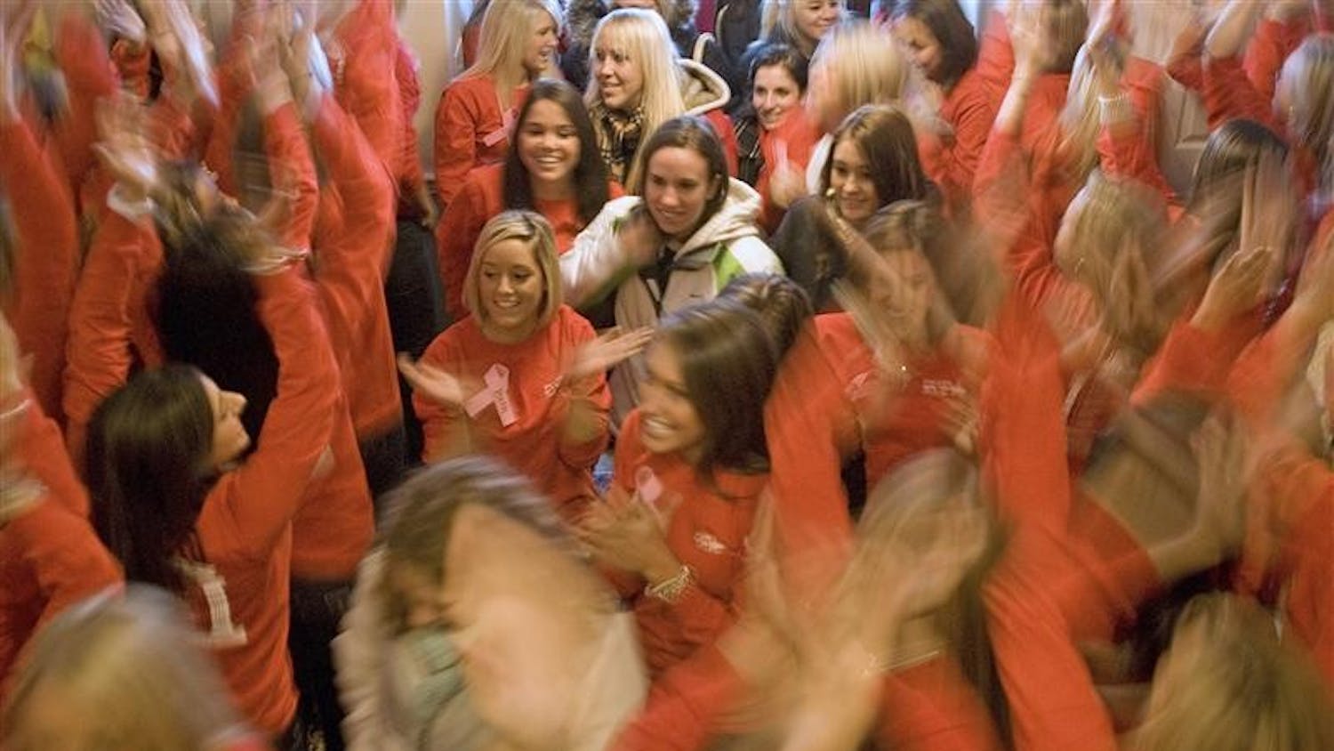 Members of Zeta Tau Alpha cheer and usher in potential members during "19 Party" Saturday at their sorority house.