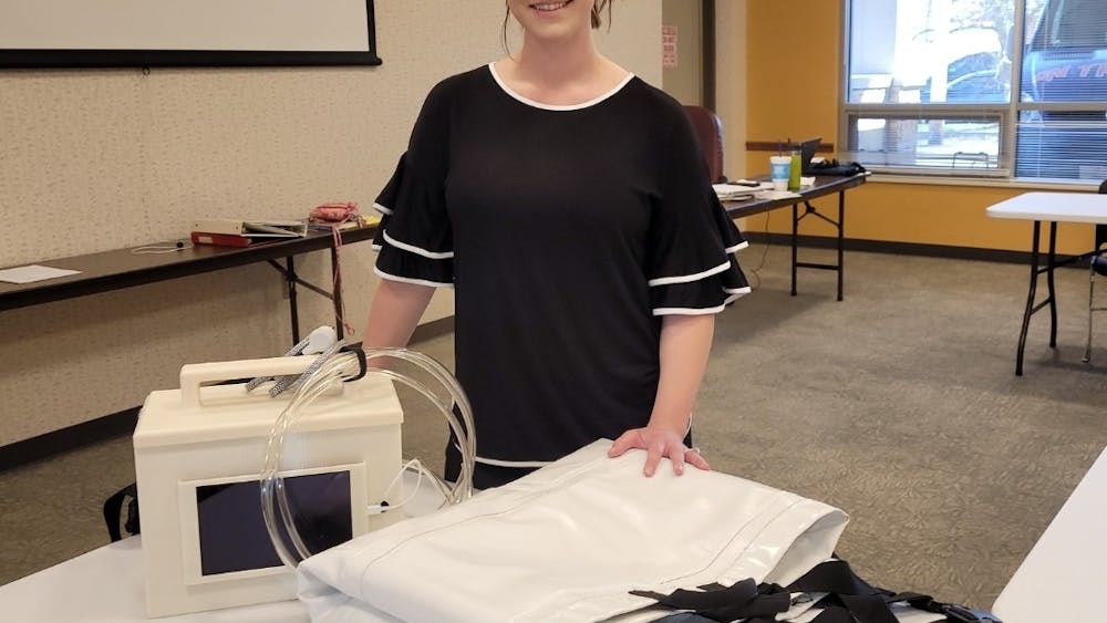 IU alumnus Morgan Miller presents her device, the Morganleigh. The device helps patient care technicians turn patients on the bed in a safer and more comfortable way.