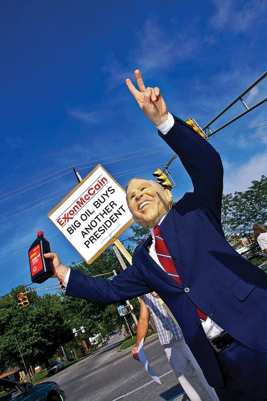 Bloomington resident Steve Mascari, wearing a President George W. Bush mask, and members of MoveOn.org protest Wednesday evening at the corner of Rogers Street and Kirkwood Avenue. MoveOn.org was protesting against politicians they believe are responsible for high gas prices.