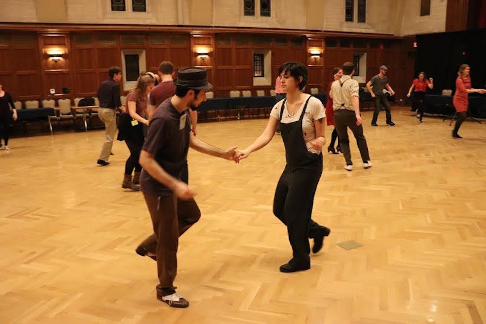 <p>Erfan Sadeqi Azer dances with Jenna Richards during the Swing Dance Club callout meeting Monday. Azer, the Swing Dance Club's president, danced with students interested in the club.</p>