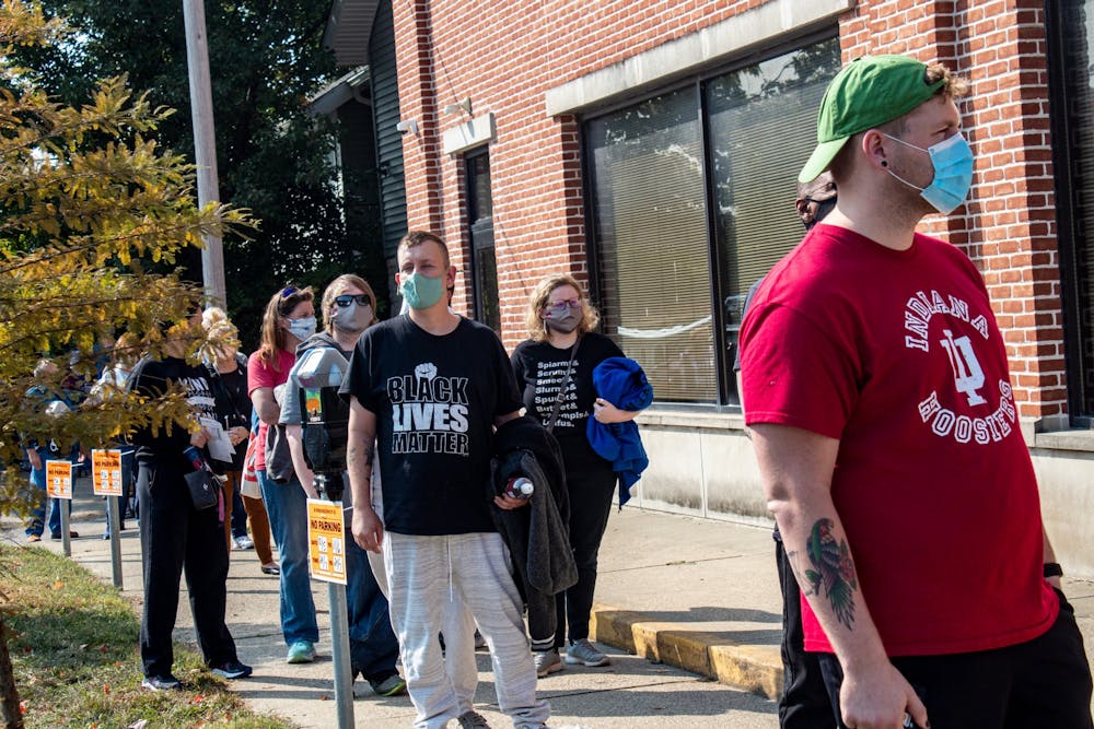 <p>Voters wait in line to vote Tuesday at Election Central at 401 W. Seventh St. Voters said wait times were roughly an hour despite the long line on the first day of early voting in Indiana.</p>
