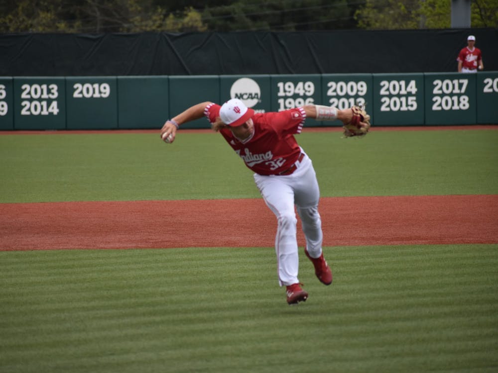 Freshman third baseman Josh Pyne throws to first base April 30, 2022, at Bart Kaufman Field. Indiana&#x27;s record moved to 20-24 with its win over Illinois on Sunday and has won seven of its last 10 games.