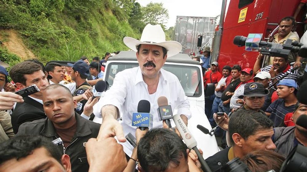 Honduras' President Manuel Zelaya greets supporters in Las Manos, Nicaragua, Saturday, July 25, 2009. Honduras' coup-installed government has ordered people off the streets along its border with Nicaragua as the ousted President Zelaya prepares to return home.