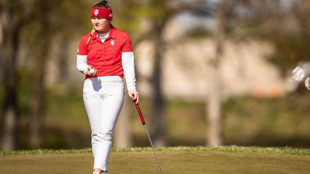 <p>Then-sophomore Valerie Clancy examines the course April 18, 2021, at the Pfau Course in Bloomington. Clancy scored a 2-over 146 to come in second at the Courtney Cole Invitational at Pfau Course. </p>