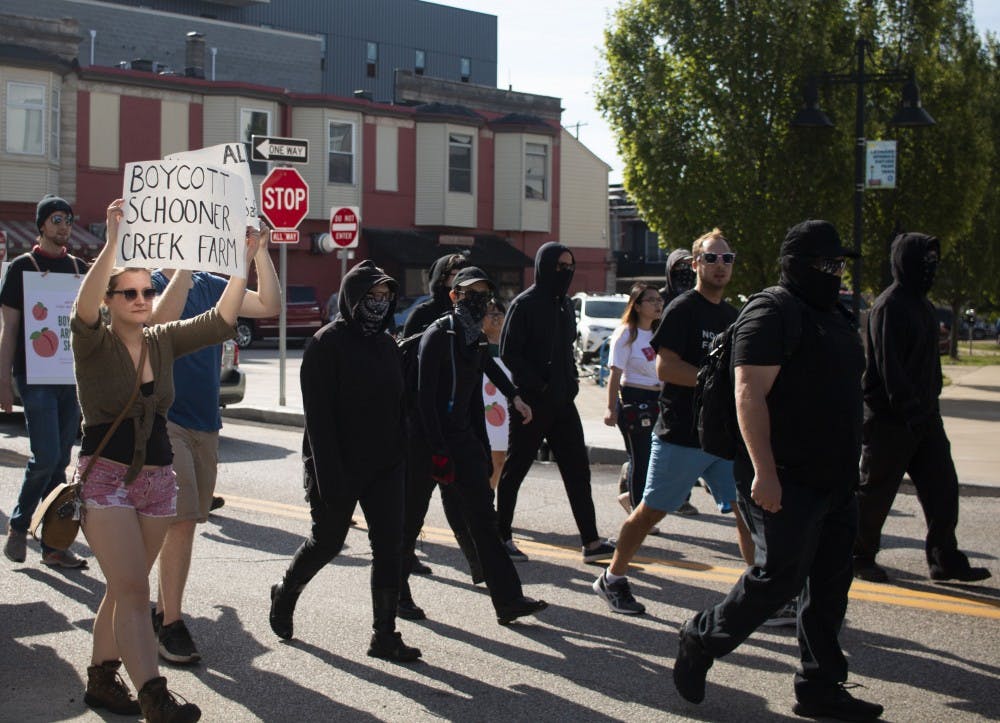 <p>Members of the Bloomington community, antifa, and No Space for Hate march toward the Bloomington Community Farmers’ Market on Aug. 24 to protest the continued presence of the vendor Schooner Creek Farm. The market has been under scrutiny as of late, due to the continued presence of Schooner Creek Farm, which is run by people with alleged ties to white nationalism. </p>